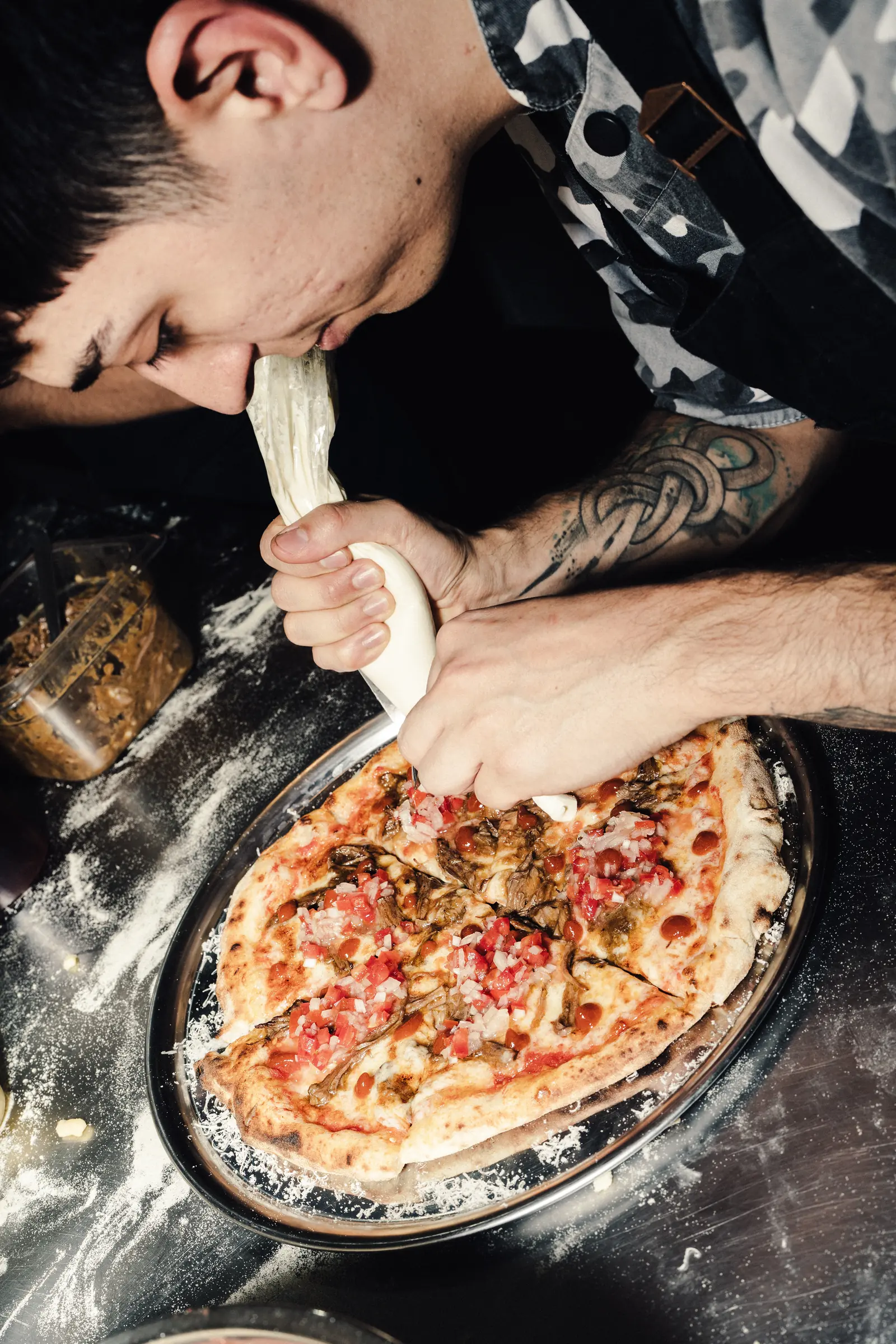 Terminación a mano de una pizza en la cocina